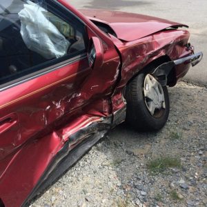 A car with a crushed passenger door.