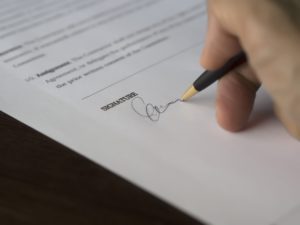 Close-up view of someone doing a signature