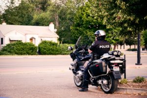 A police officer sitting on his motorcycle.