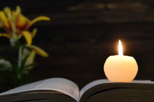 A candle, book, and flower memorialize a wrongful death victim