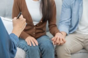 a couple holding hands while meeting with a Bridgeport medical malpractice lawyer