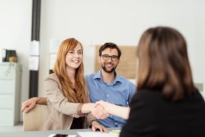 a happy young couple meeting their New Haven personal injury lawyer