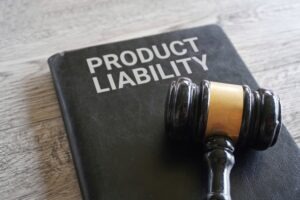 a product liability book and a gavel on a wooden surface