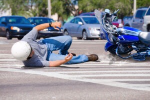 Man lies on street next to motorcycle after Waterbury accident