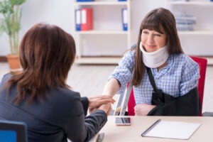 a female attorney talking to an injured woman after a Norwich jackknife truck accident