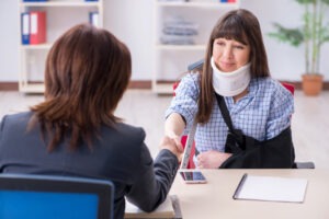 An injured woman shakes hands with a product liability lawyer in Waterbury.