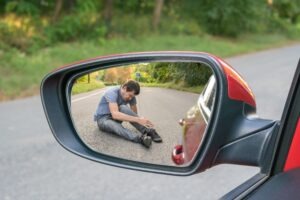 A man considers calling a Norwich pedestrian accident lawyer after being hit by a car.