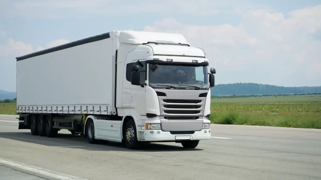 White semi-truck driving on the road