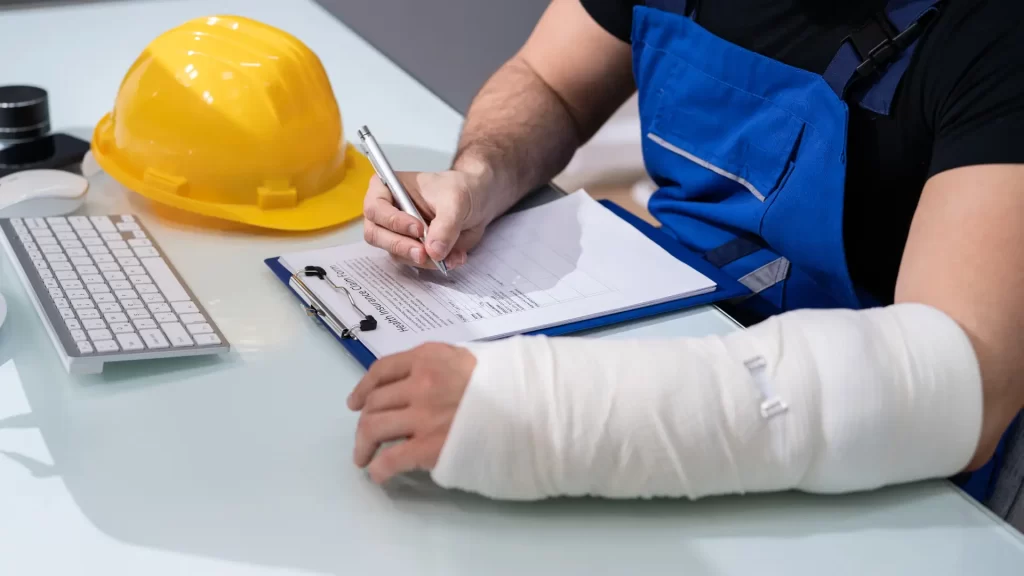 Injured worker with arm cast filling out paperwork