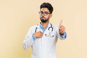 A doctor shaking his finger “no” while a patient wonders what they can do if their doctor refuses to treat them.