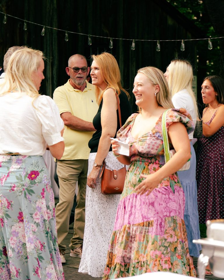Guests mingle outdoors at An Evening with Zac Clark and Friends